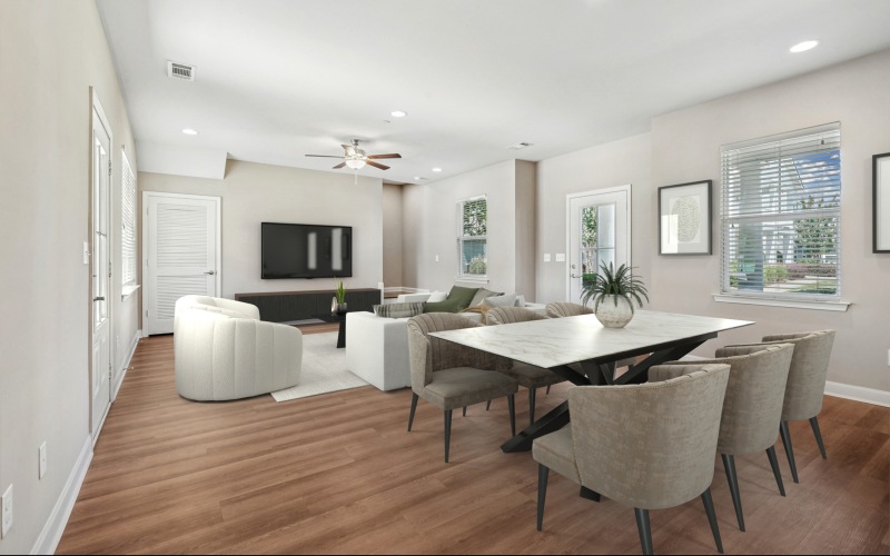 Room with a kitchen table with seating, lounge seating , three windows, and a tv on the wall